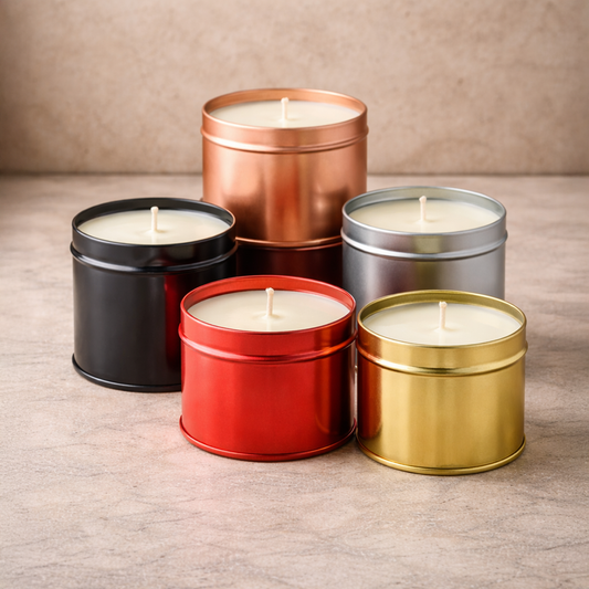 Five luxury soy wax tin candles in black, copper, silver, red and gold on a stone background